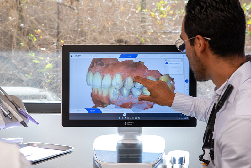 doctor looking over a 3d model of Patients teeth