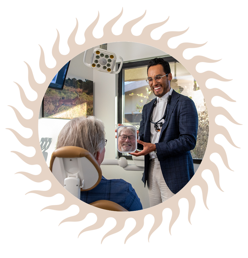 Patient Smiling into mirror that doctor is holding