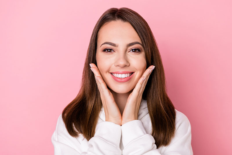 Patient smiling after teeth whitening procedure